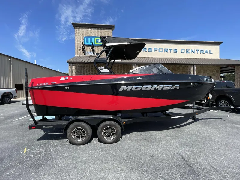 Slide: The Image of 2023 Moomba Craz boat in red and black on trailer, parked outside dealership. - 15