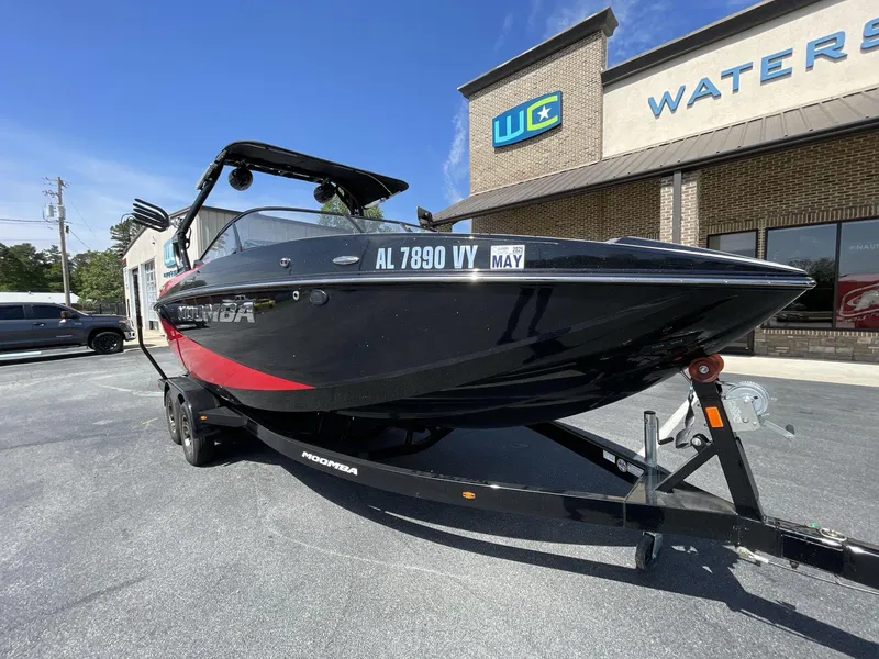 Slide: The Image of 2023 Moomba Craz boat on trailer, parked outside dealership under clear blue sky. - 16
