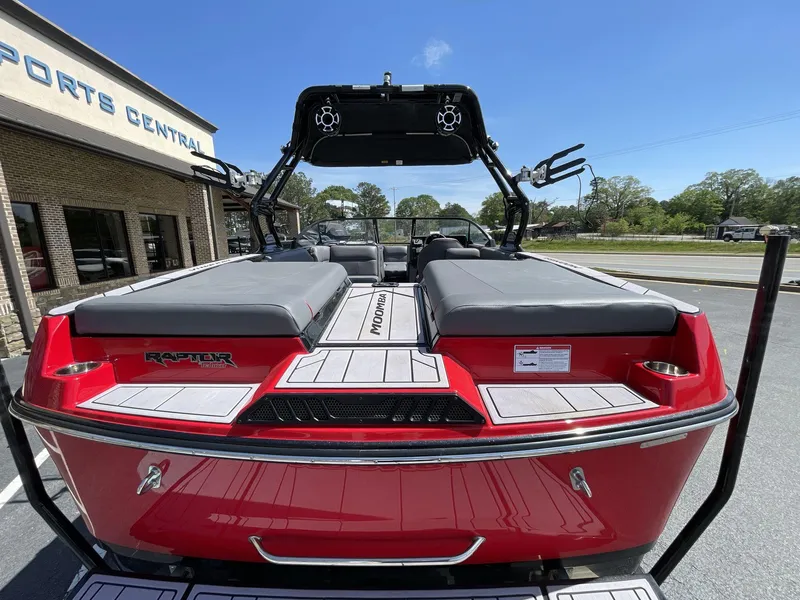 Slide: The Image of 2023 Moomba Craz boat, red exterior, rear view, parked at Sports Central dealership. - 18