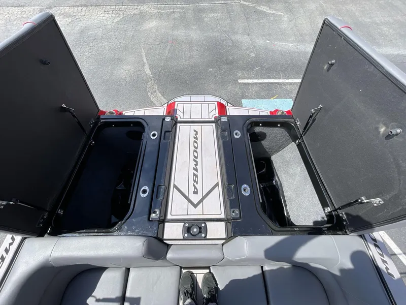 Slide: The Image of 2023 Moomba Craz boat storage compartments open, showcasing spacious interior design. - 22