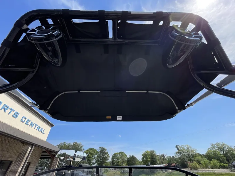 Slide: The Image of 2023 Moomba Craz boat canopy with speakers, under clear blue sky. - 25