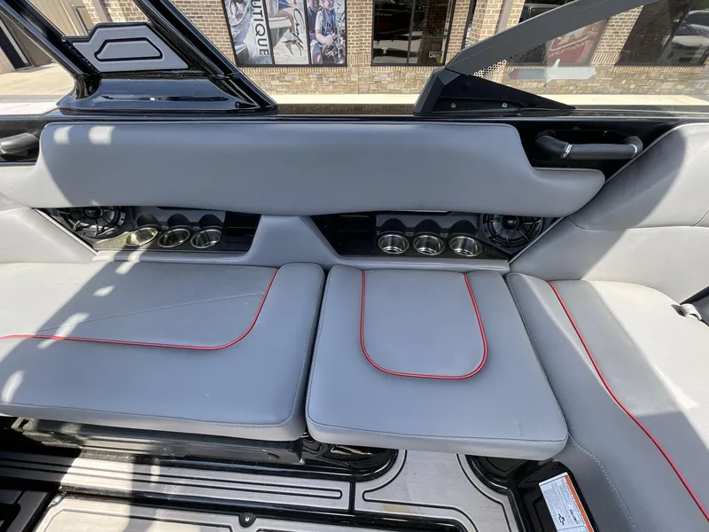 Slide: The Image of 2023 Moomba Craz boat interior with gray seating and red accents. - 28