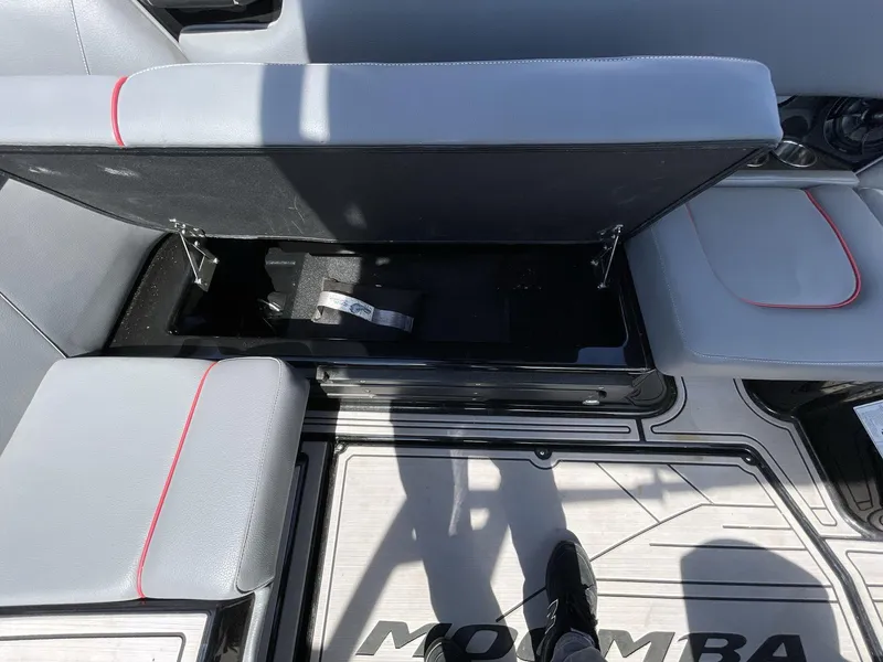 Slide: The Image of 2023 Moomba Craz boat interior with open storage compartment and gray seating. - 31