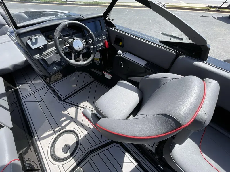 Slide: The Image of 2023 Moomba Craz boat interior with sleek steering wheel and modern seating design. - 32