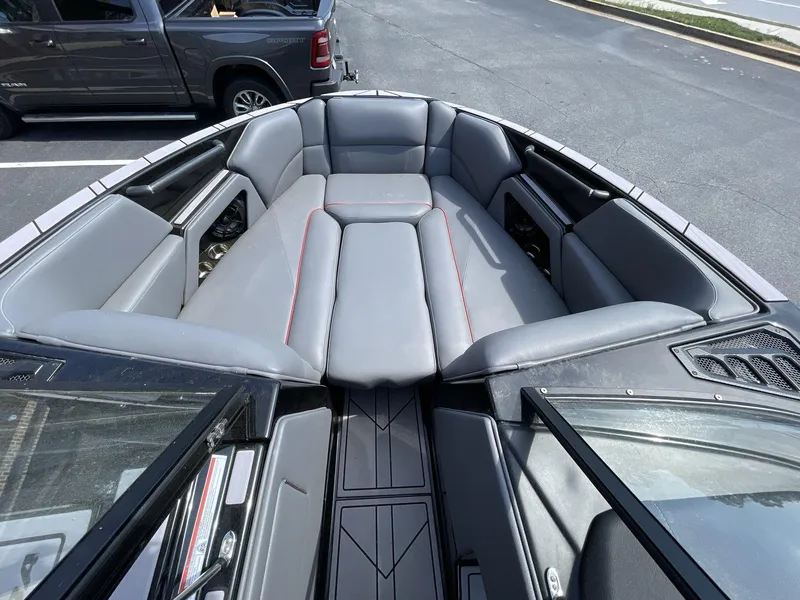 Slide: The Image of 2023 Moomba Craz boat interior with gray seating and red accents. - 37