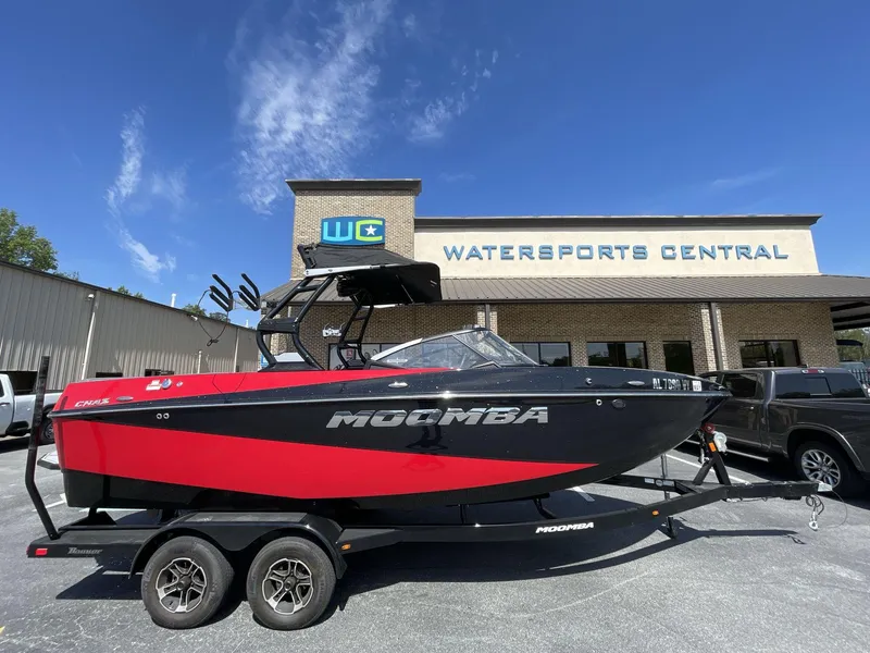 Slide: The Image of 2023 Moomba Craz boat in red and black at Watersports Central dealership. - 6