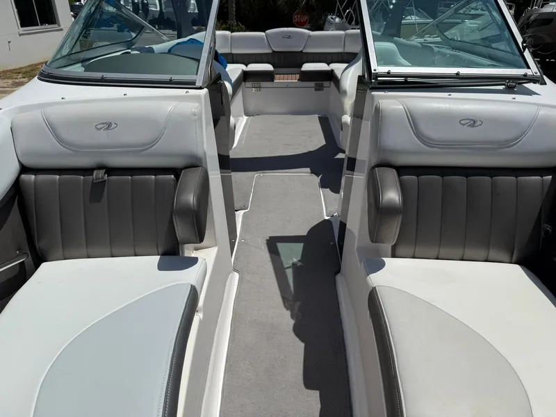 Slide: The Image of 2011 Regal 2500 Bowrider interior with gray seating and open layout. - 14