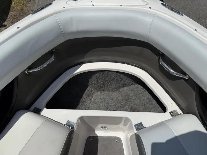 Slide: The Image of 2011 Regal 2500 Bowrider interior with gray seating and stainless steel handles. - 16