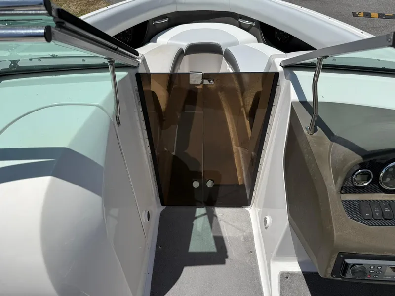 Slide: The Image of 2011 Regal 2500 Bowrider interior with open windshield and dashboard view. - 19