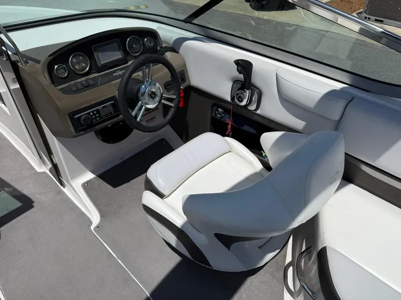 Slide: The Image of 2011 Regal 2500 Bowrider boat interior with steering wheel and captain's seat. - 21