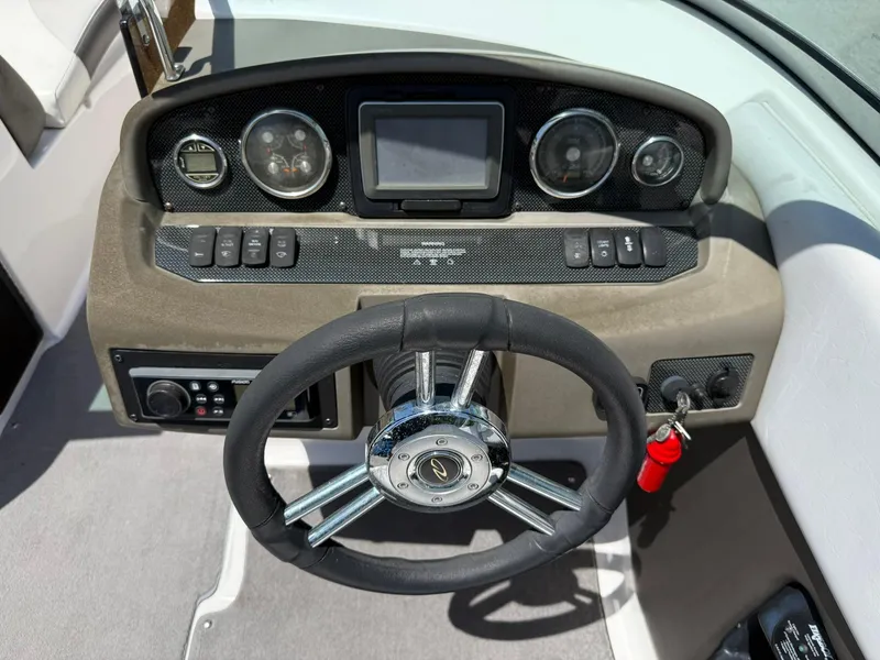 Slide: The Image of 2011 Regal 2500 Bowrider dashboard with steering wheel and control panel. - 22