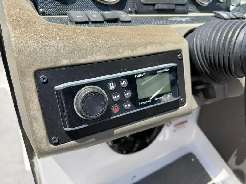 Slide: The Image of Control panel of a 2011 Regal 2500 Bowrider boat with Fusion audio system. - 23