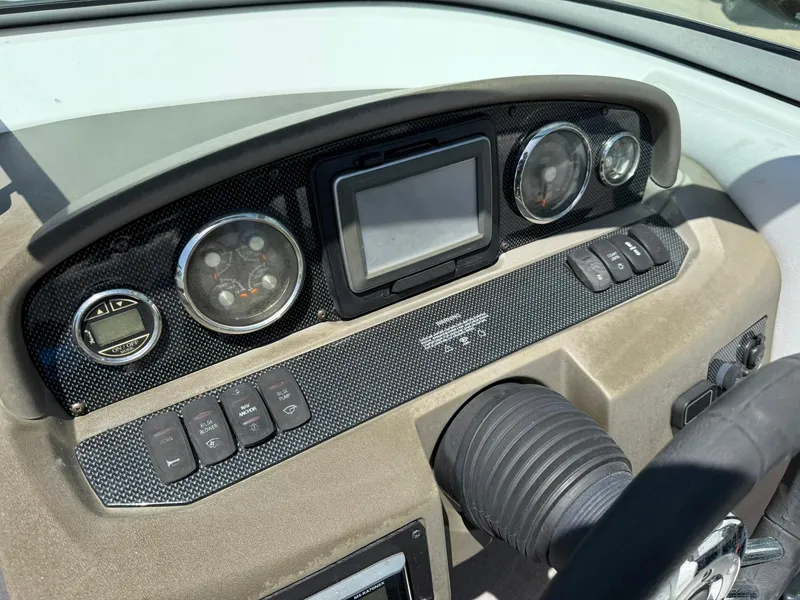 Slide: The Image of Dashboard of 2011 Regal 2500 Bowrider boat with gauges and controls. - 24