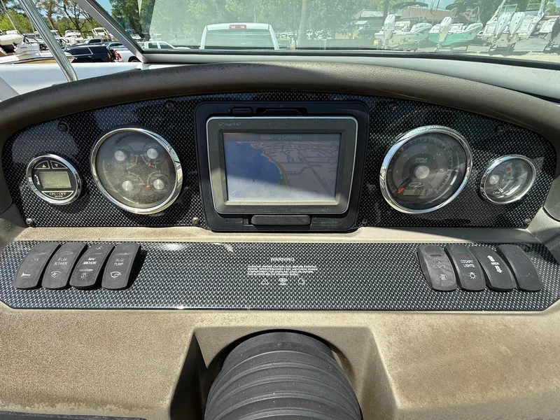 Slide: The Image of Dashboard of a 2011 Regal 2500 Bowrider boat with navigation display and controls. - 25