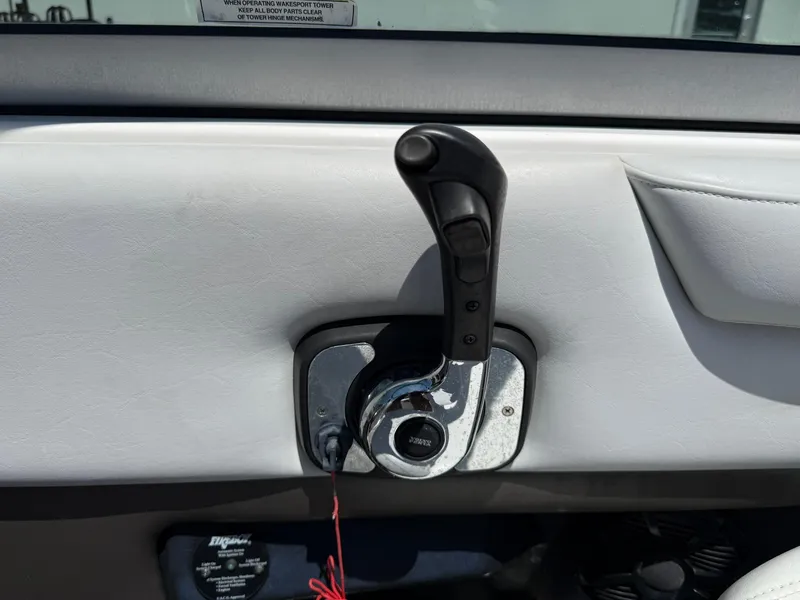 Slide: The Image of Throttle control lever on a 2011 Regal 2500 Bowrider boat dashboard. - 27