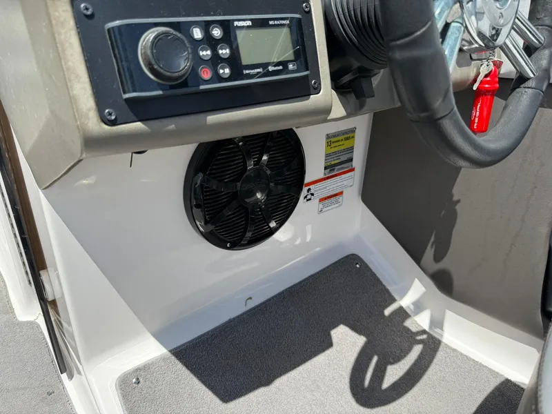 Slide: The Image of 2011 Regal 2500 Bowrider dashboard with controls, steering wheel, and speaker. - 28