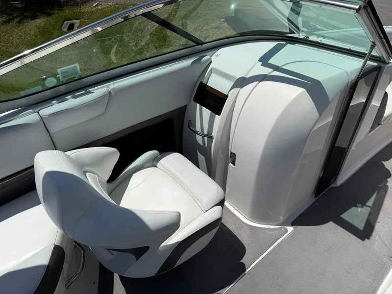 Slide: The Image of 2011 Regal 2500 Bowrider interior with sleek white seating and modern dashboard design. - 29