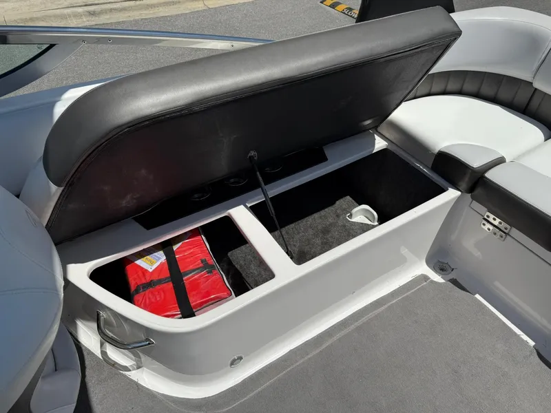 Slide: The Image of 2011 Regal 2500 Bowrider storage compartment with life jacket and accessories. - 32