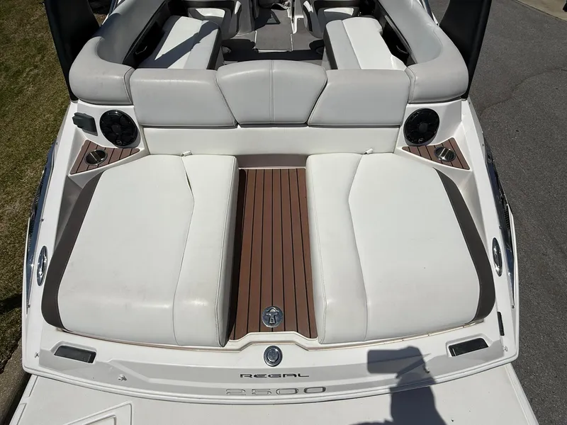 Slide: The Image of 2011 Regal 2500 Bowrider boat with white seating and wood accents. - 35
