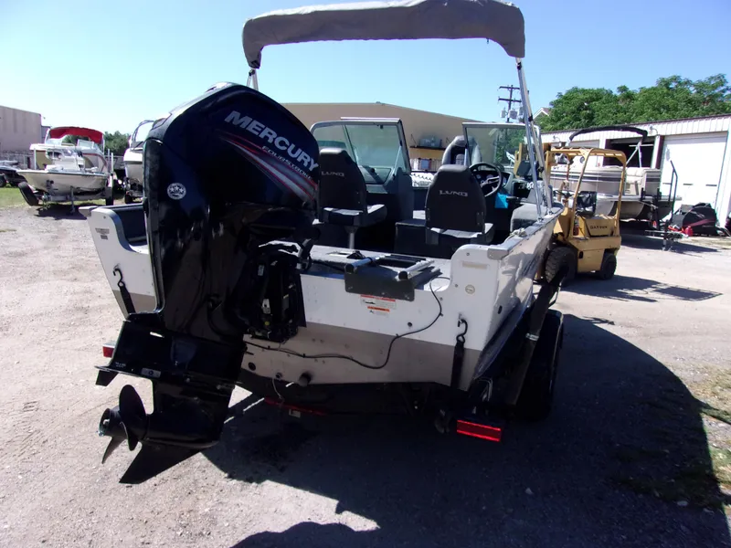 Slide: The Image of 2017 Lund 1775 Impact Sport boat with Mercury outboard motor, parked outdoors. - 3