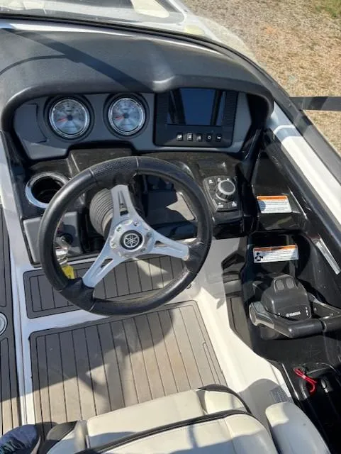 Slide: The Image of 2016 Yamaha Boats 242 Limited S dashboard with steering wheel and controls. - 11