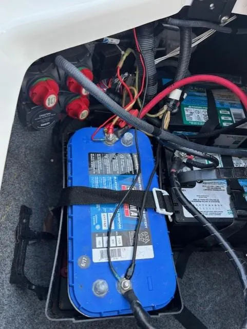 Slide: The Image of Battery compartment of a 2016 Yamaha Boats 242 Limited S with wiring and connections. - 13