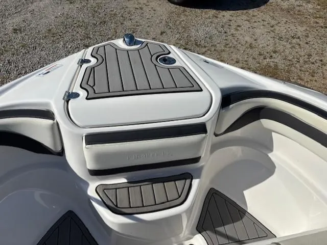 Slide: The Image of 2016 Yamaha Boats 242 Limited S bow seating area with gray and white upholstery. - 9