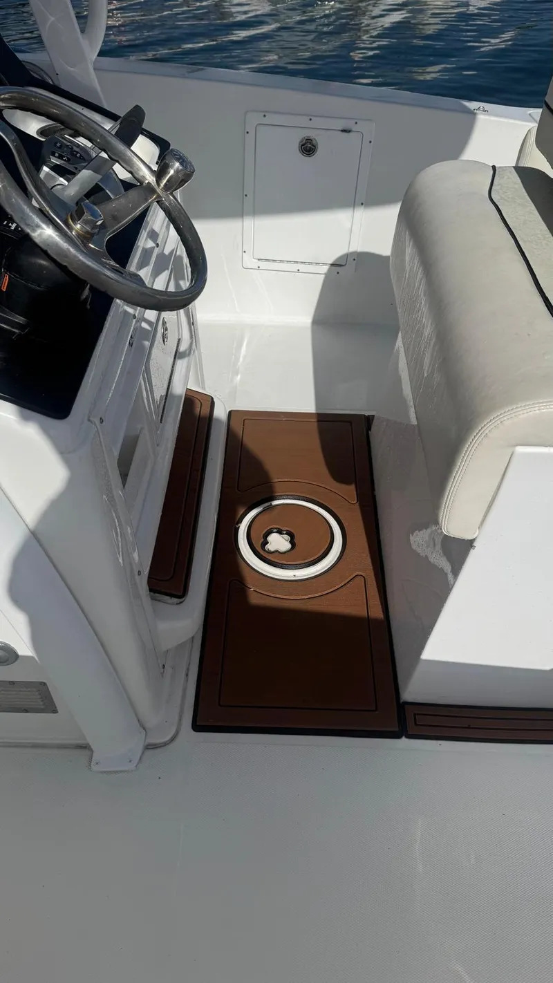 Slide: The Image of 2013 Sea Hunt Gamefish 29 boat interior with steering wheel and seating. - 11