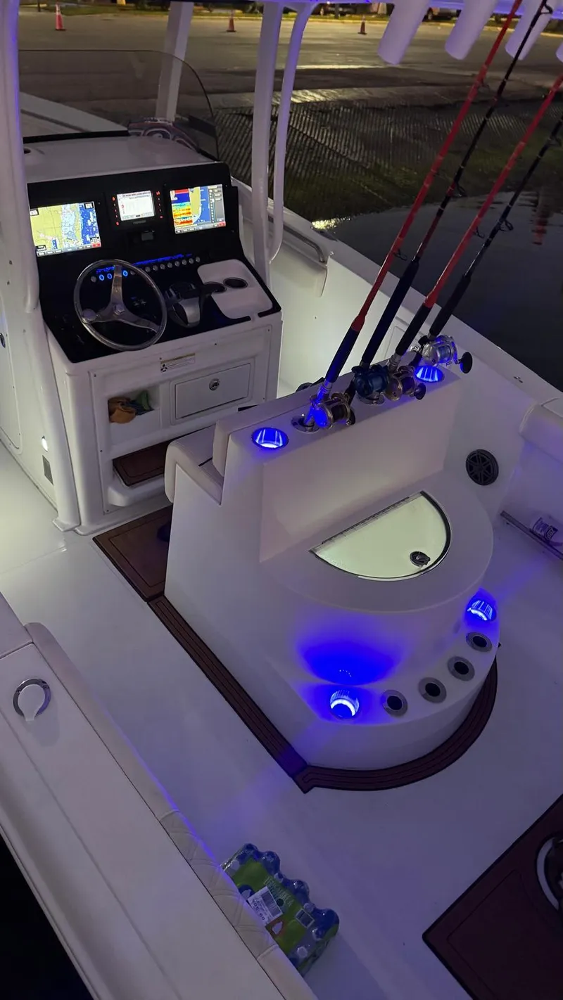Slide: The Image of 2013 Sea Hunt Gamefish 29 boat interior with illuminated fishing rod holders and control panel. - 15