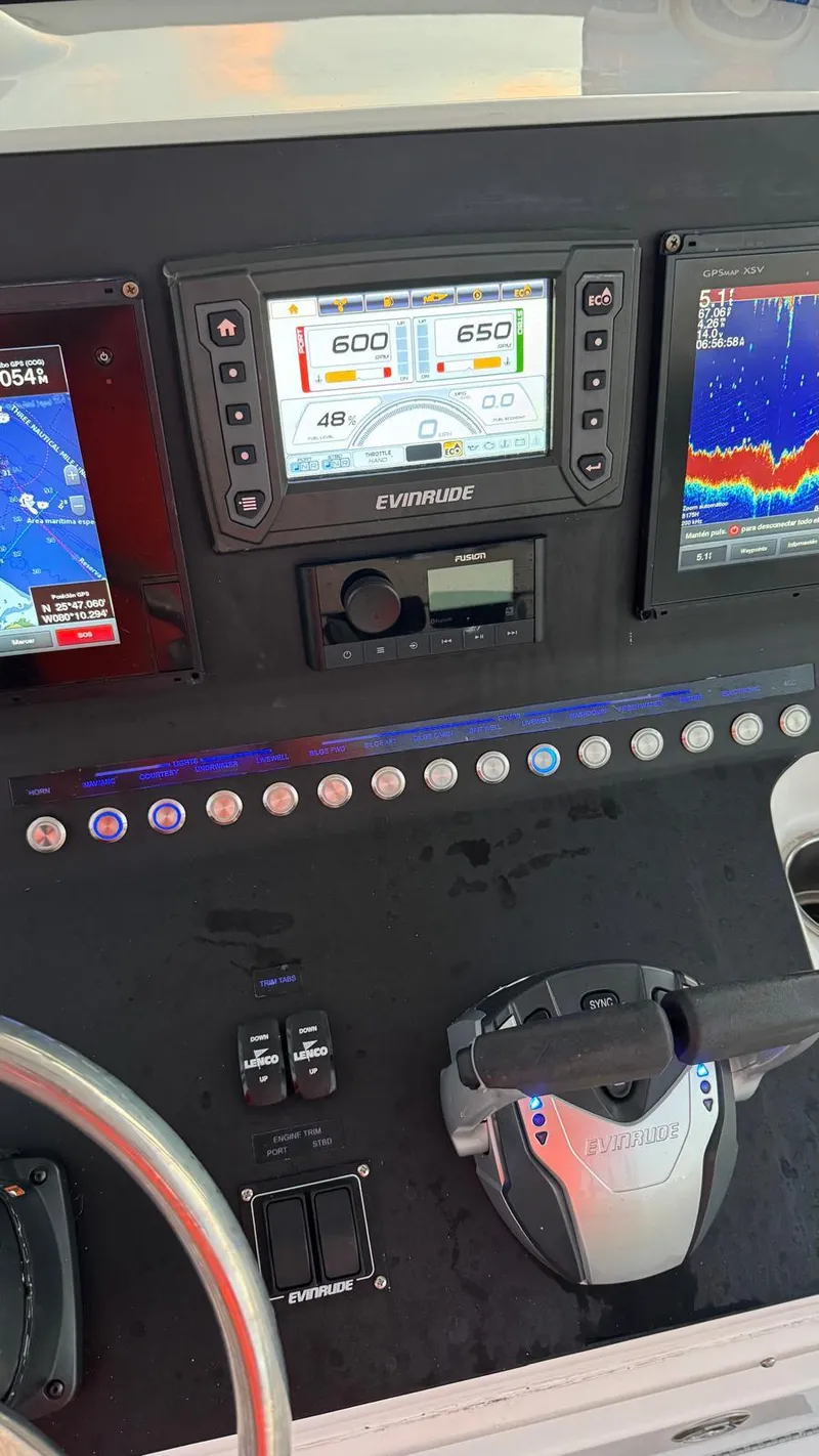 Slide: The Image of Control panel of a 2013 Sea Hunt Gamefish 29 boat with navigation displays. - 16