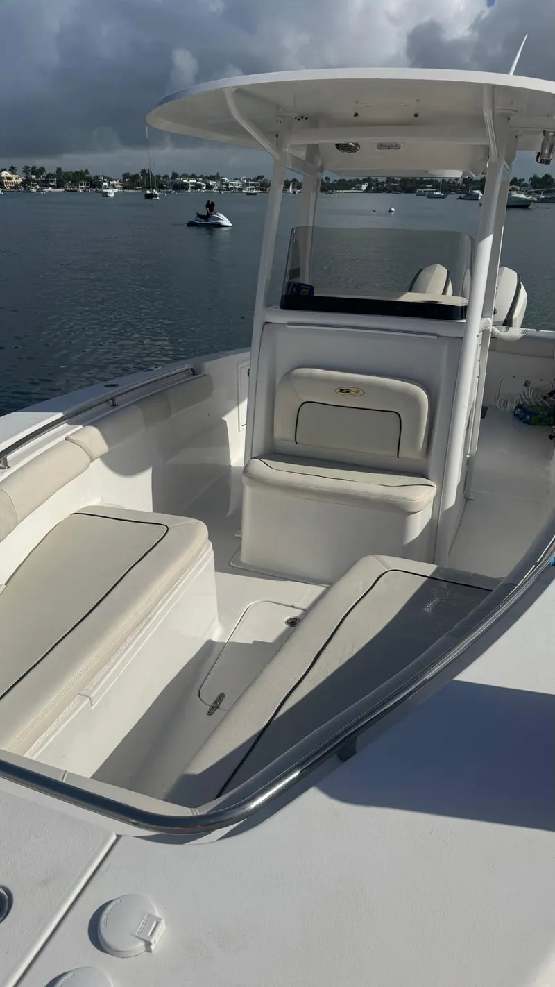 Slide: The Image of 2013 Sea Hunt Gamefish 29 boat with spacious seating on calm water. - 18