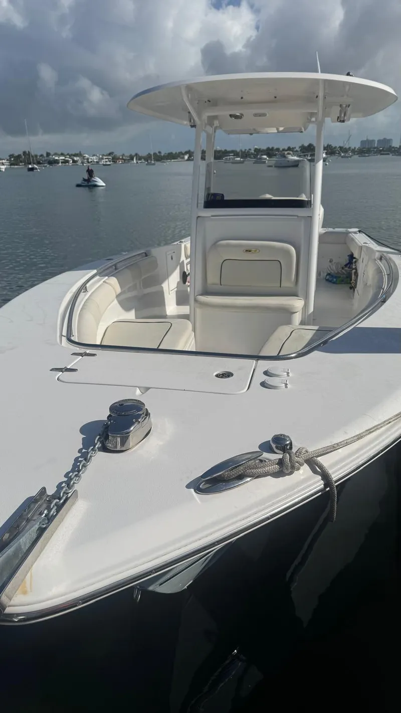 Slide: The Image of 2013 Sea Hunt Gamefish 29 boat on calm water, featuring a sleek design and spacious deck. - 3