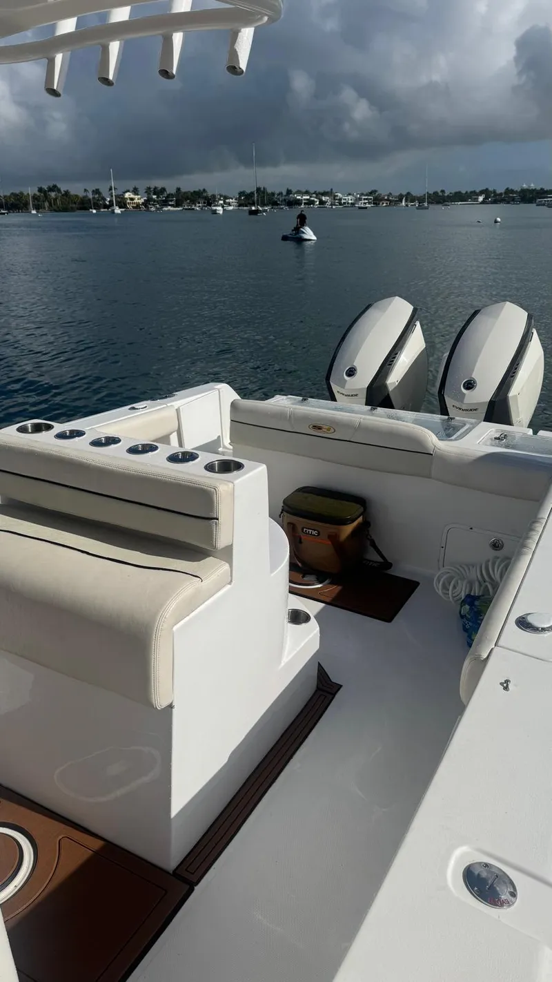 Slide: The Image of 2013 Sea Hunt Gamefish 29 boat with dual engines on a calm water backdrop. - 7