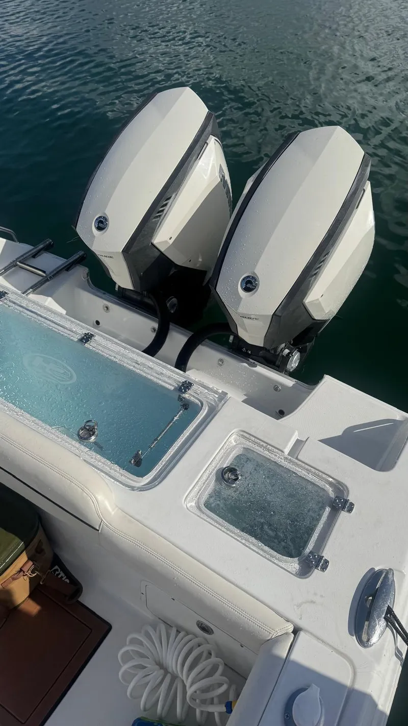 Slide: The Image of 2013 Sea Hunt Gamefish 29 with dual outboard motors on calm water. - 8
