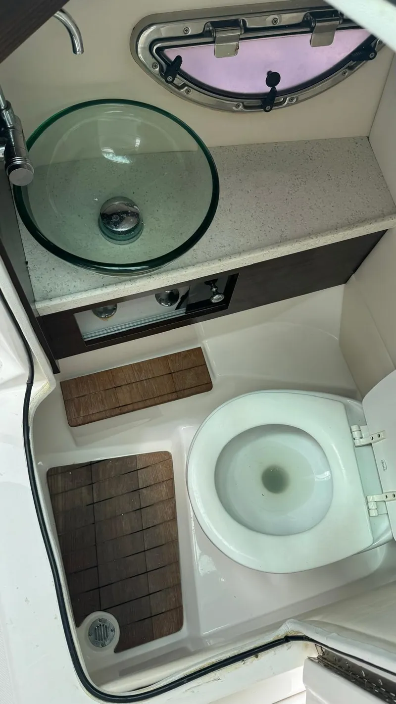 Slide: The Image of 2017 Regal 29 OBX boat bathroom with glass sink and toilet. - 10