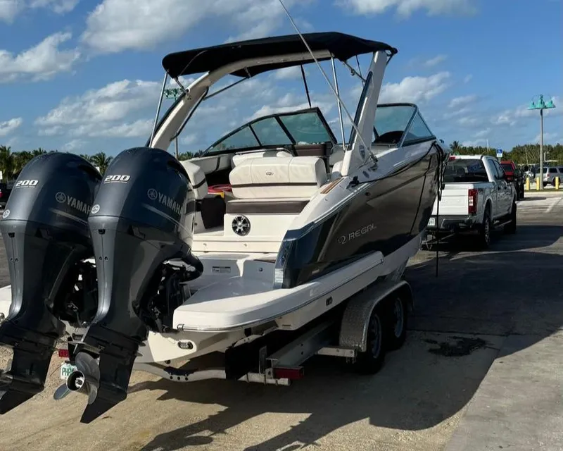 Slide: The Image of 2017 Regal 29 OBX boat with twin Yamaha engines on a trailer. - 2