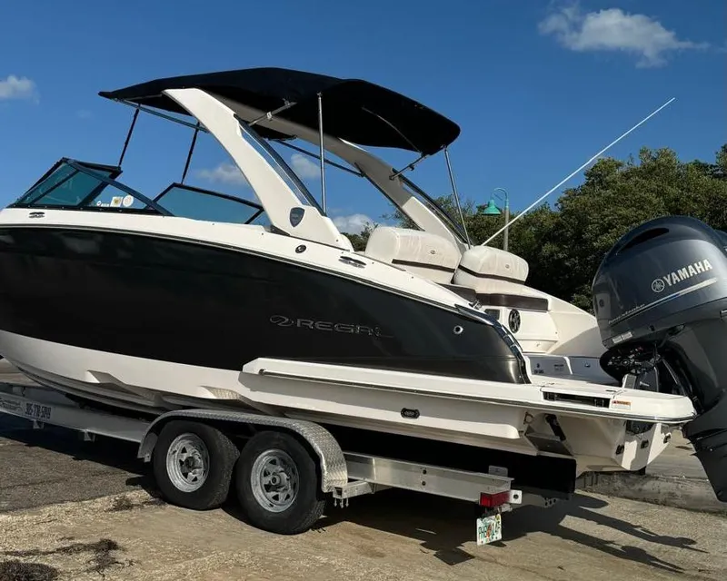 Slide: The Image of 2017 Regal 29 OBX boat on trailer with Yamaha outboard motor, parked outdoors. - 3