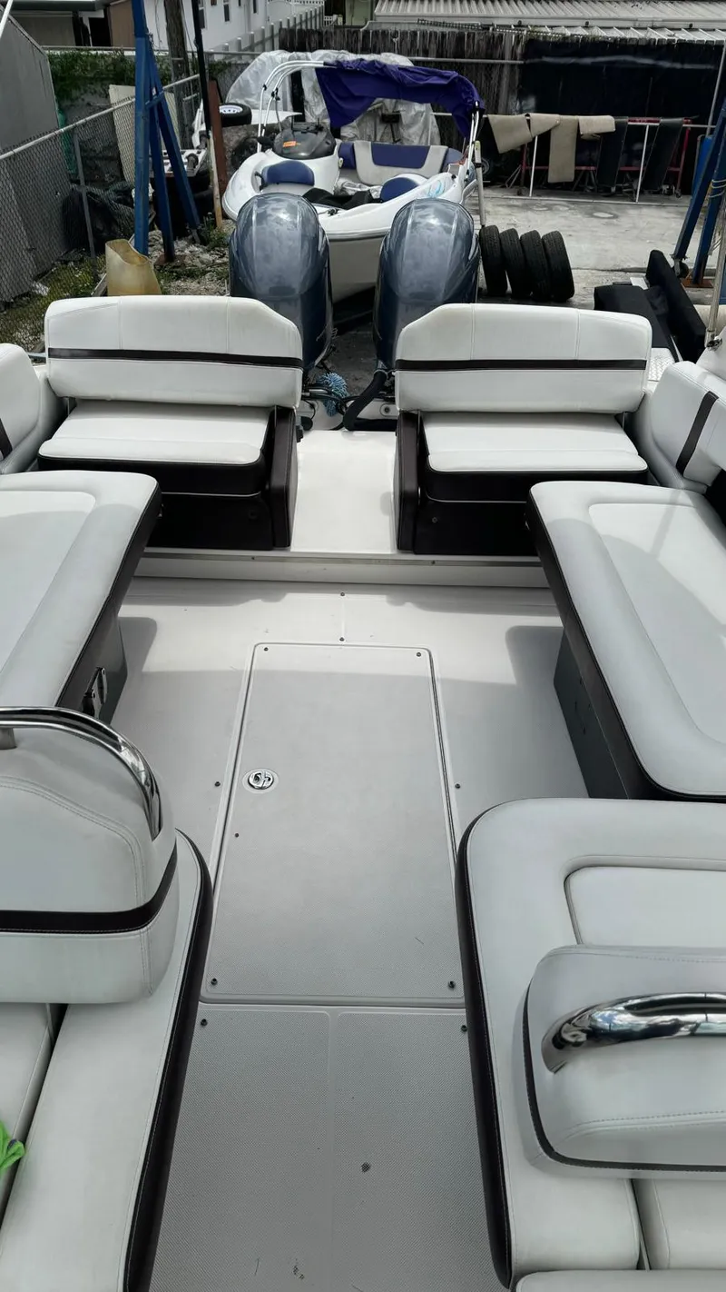 Slide: The Image of 2017 Regal 29 OBX boat interior with white seating and dual outboard motors. - 5