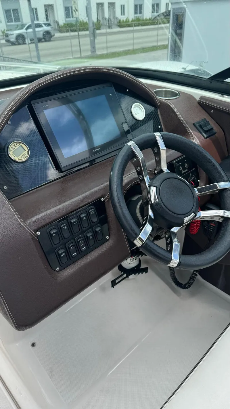 Slide: The Image of 2017 Regal 29 OBX boat dashboard with steering wheel and control panel. - 7