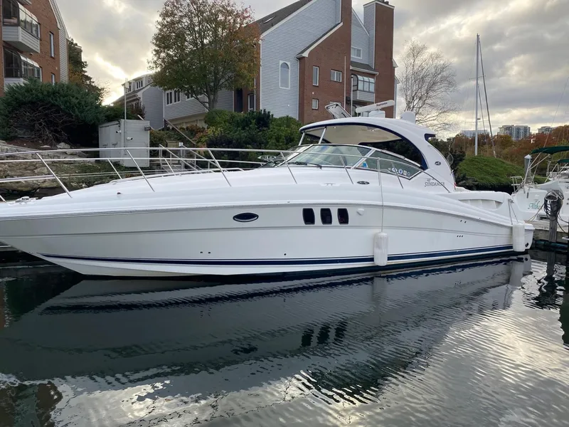 Slide: The Image of 2007 Sea Ray 40 Sundancer yacht docked near waterfront homes. - 0