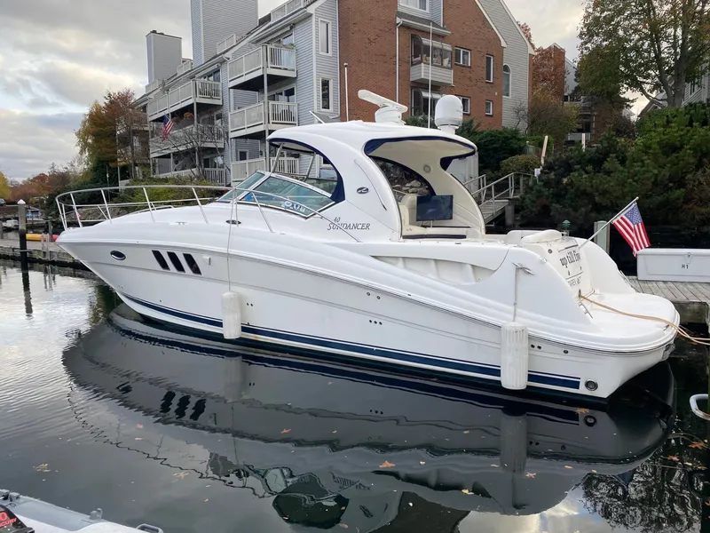 Slide: The Image of 2007 Sea Ray 40 Sundancer yacht docked near waterfront homes, reflecting in calm water. - 1