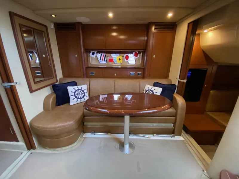 Slide: The Image of Luxurious 2007 Sea Ray 40 Sundancer interior with plush seating and elegant wooden table. - 10