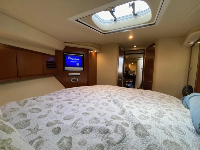 Slide: The Image of Luxurious cabin interior of 2007 Sea Ray 40 Sundancer yacht with cozy bedding and TV. - 13