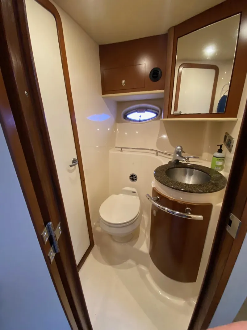 Slide: The Image of 2007 Sea Ray 40 Sundancer yacht bathroom with sink, toilet, and mirror. - 14