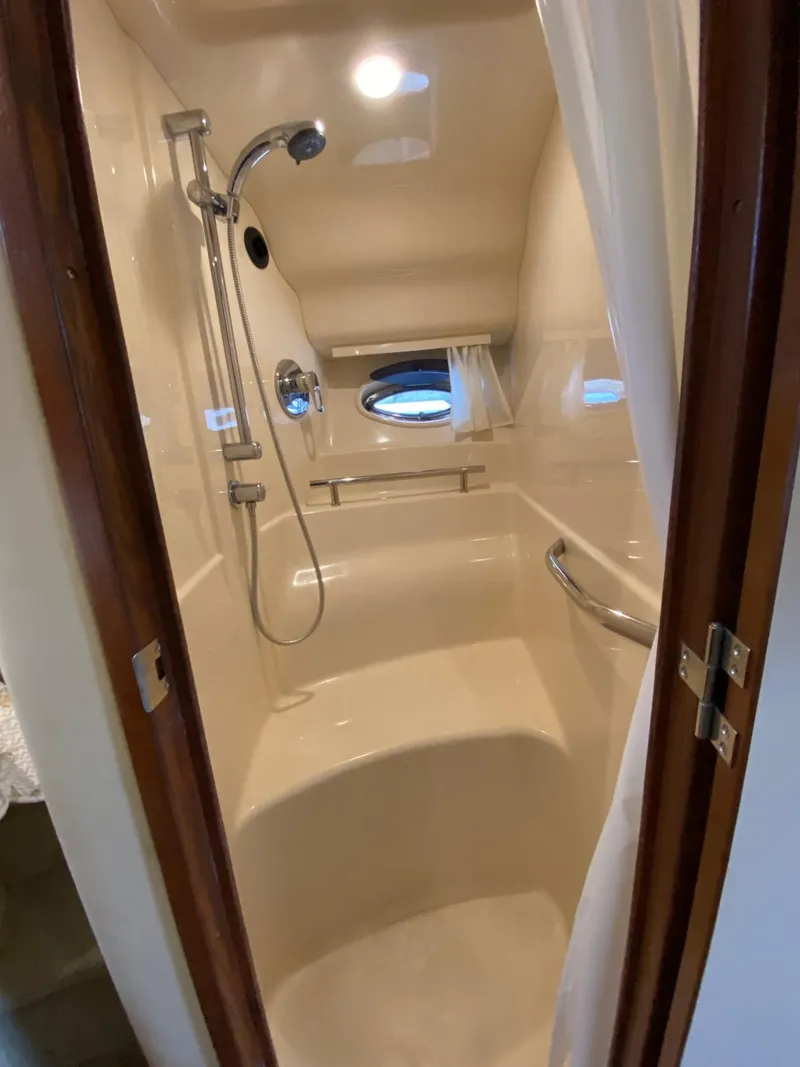 Slide: The Image of 2007 Sea Ray 40 Sundancer shower with modern fixtures and porthole window. - 15