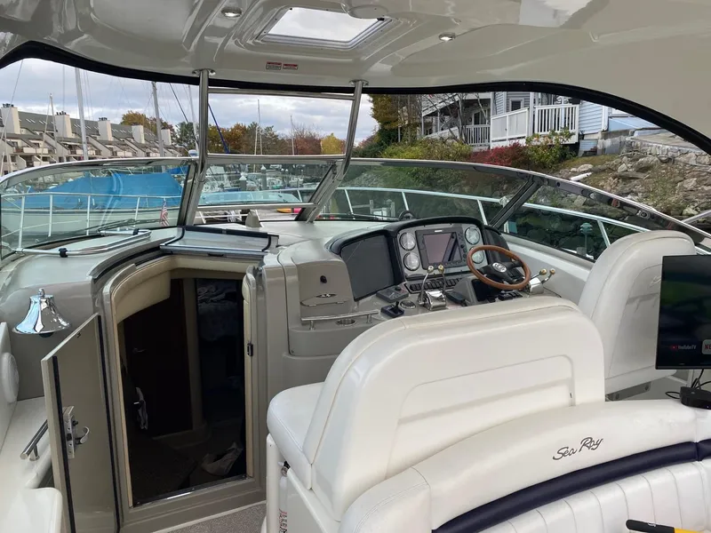 Slide: The Image of 2007 Sea Ray 40 Sundancer cockpit with helm, steering wheel, and open cabin door. - 3
