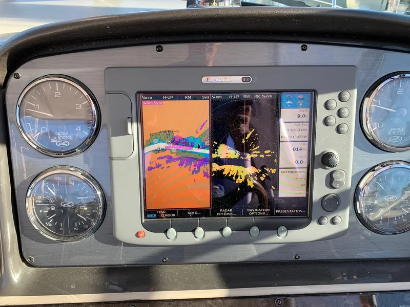 Slide: The Image of Dashboard of a 2007 Sea Ray 40 Sundancer with navigation display and gauges. - 4