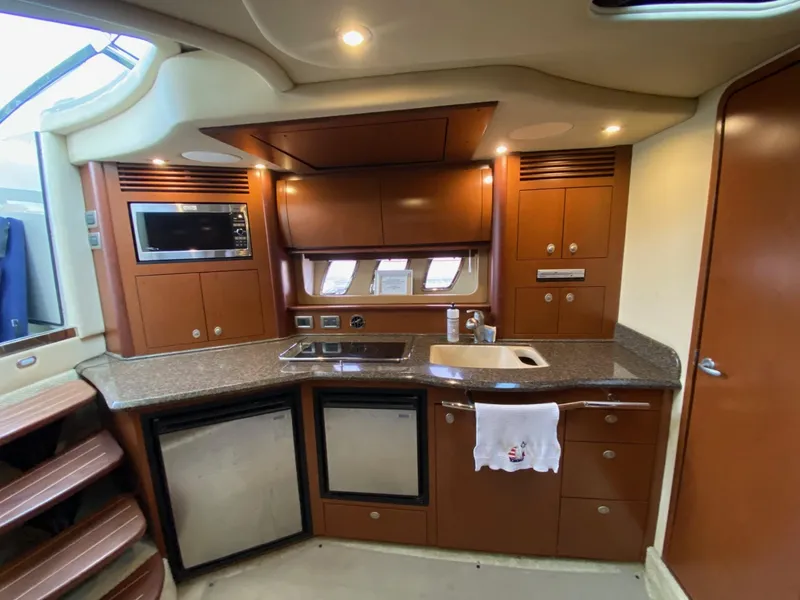 Slide: The Image of 2007 Sea Ray 40 Sundancer yacht kitchen with modern appliances and wood cabinetry. - 7