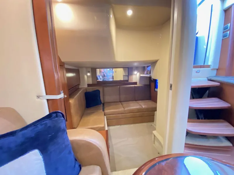 Slide: The Image of 2007 Sea Ray 40 Sundancer interior with cozy seating and elegant wooden accents. - 9