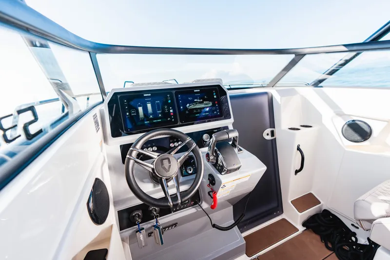 Slide: The Image of 2025 Navan S30 boat cockpit with modern steering and digital controls. - 12